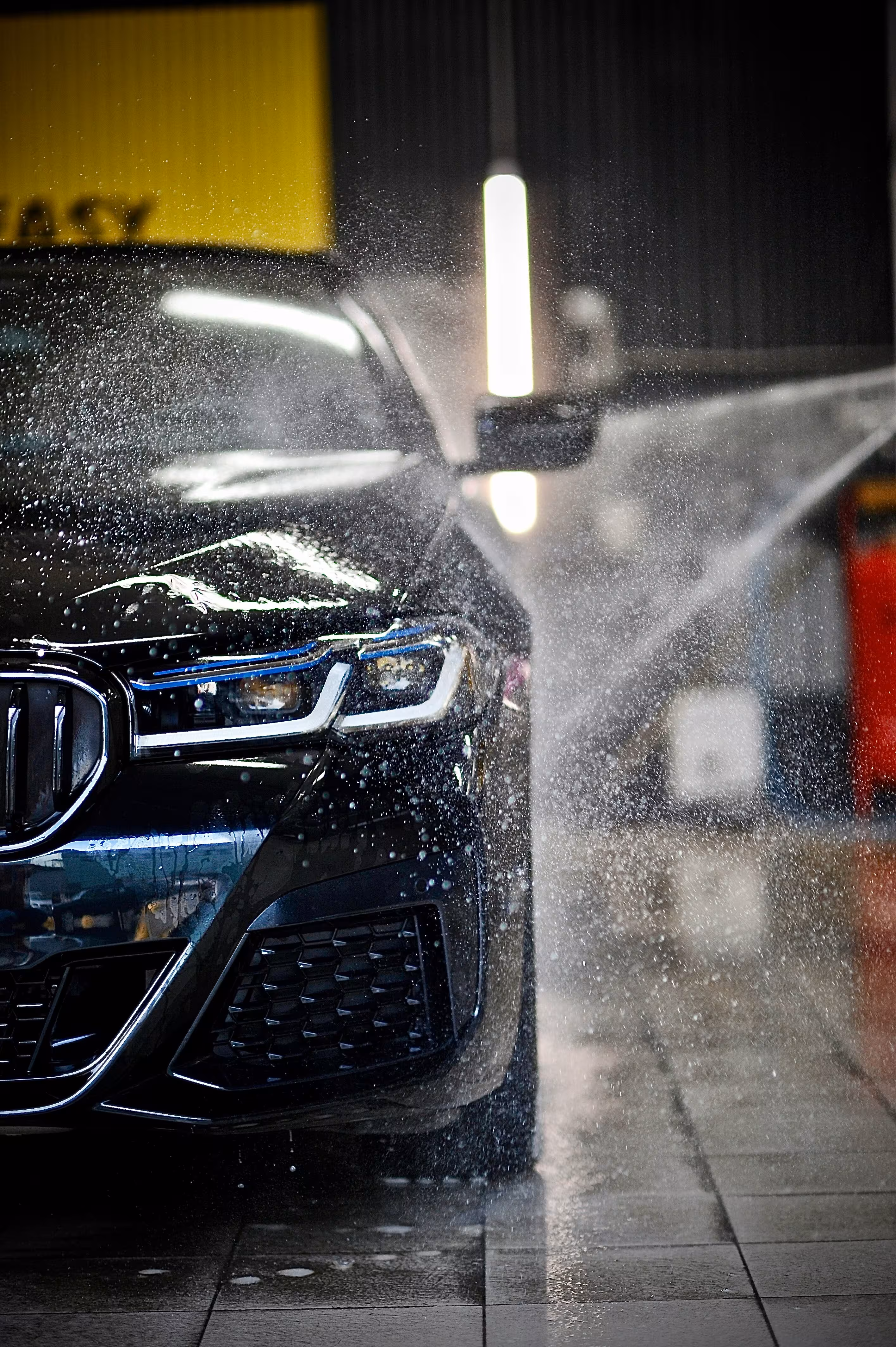 Clean blue car after professional SPADO mobile car wash service showing sparkling exterior